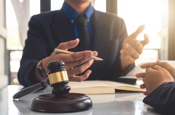 Business lawyer working about legal legislation in courtroom to help their customer
